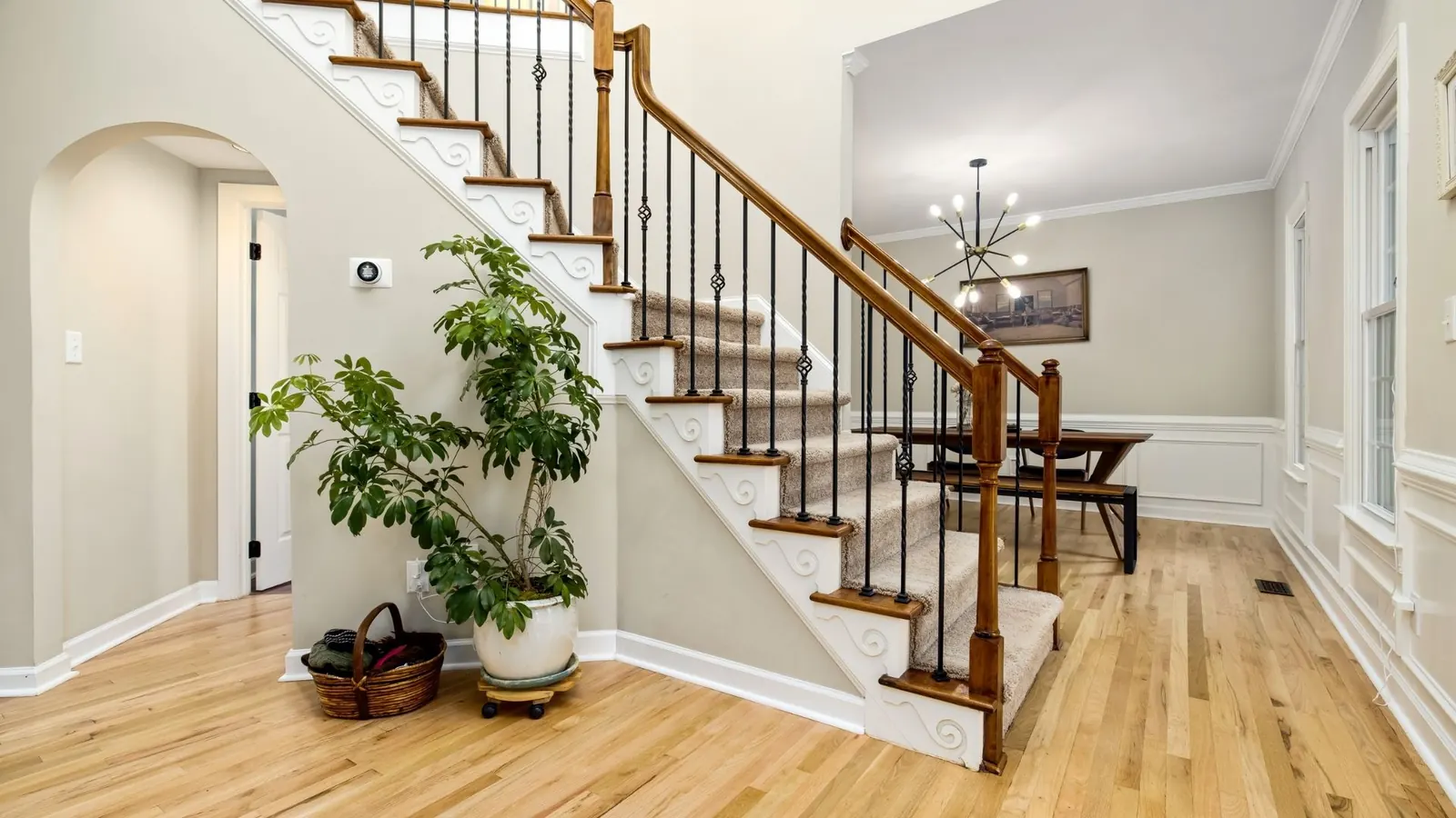 Clean residential entryway staircase and hardwood floor after maid service